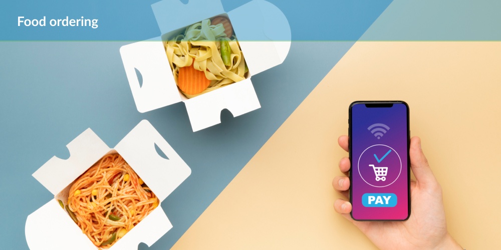 A hand holds a smartphone with a food ordering app displayed. On the screen, there's a pay button and a shopping cart icon. Open takeout boxes with noodles and vegetables are visible on a blue and yellow background. Text above reads "Food ordering."