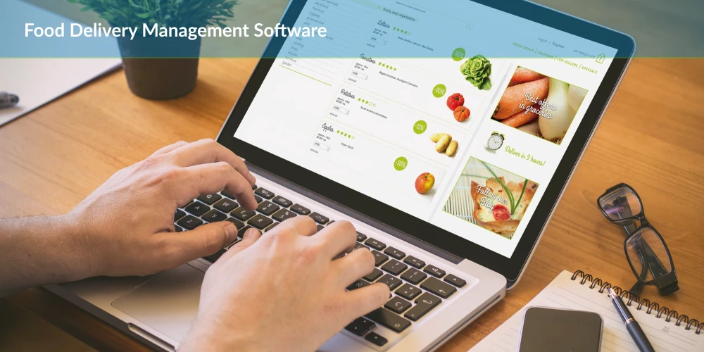 A person working a laptop representing food delivery management software .