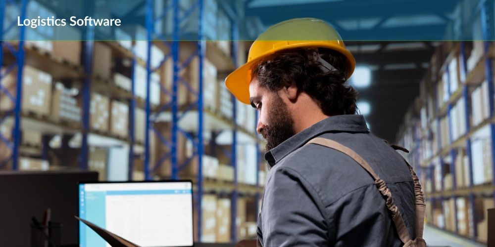 A man wearing a hard hat looking at a computer and searching for logistics software