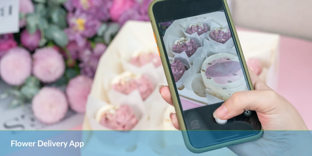 flower delivery app- a hand holding a phone with a picture of flower
