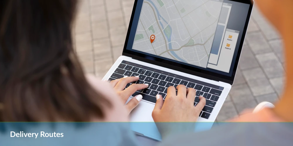 Delivery route - a woman using a laptop computer with a map on the screen