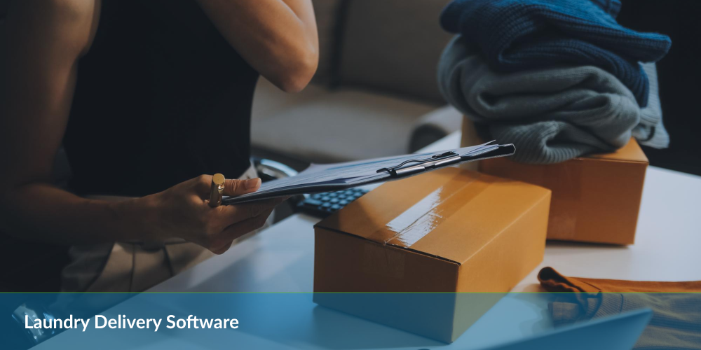 Person holding clipboard near cardboard boxes with text 'Laundry Delivery Software'.