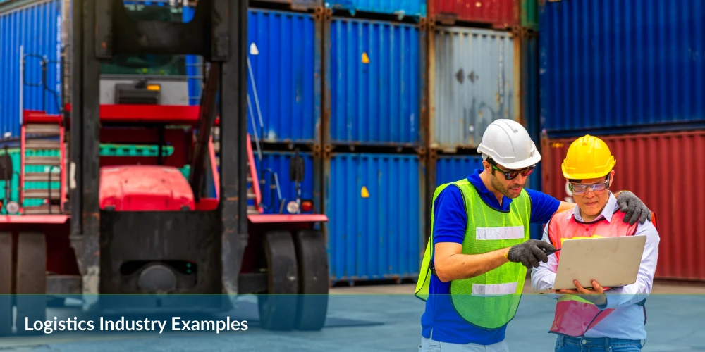 Two workers in safety gear discuss a tablet, with a red forklift and colorful shipping containers in the background.